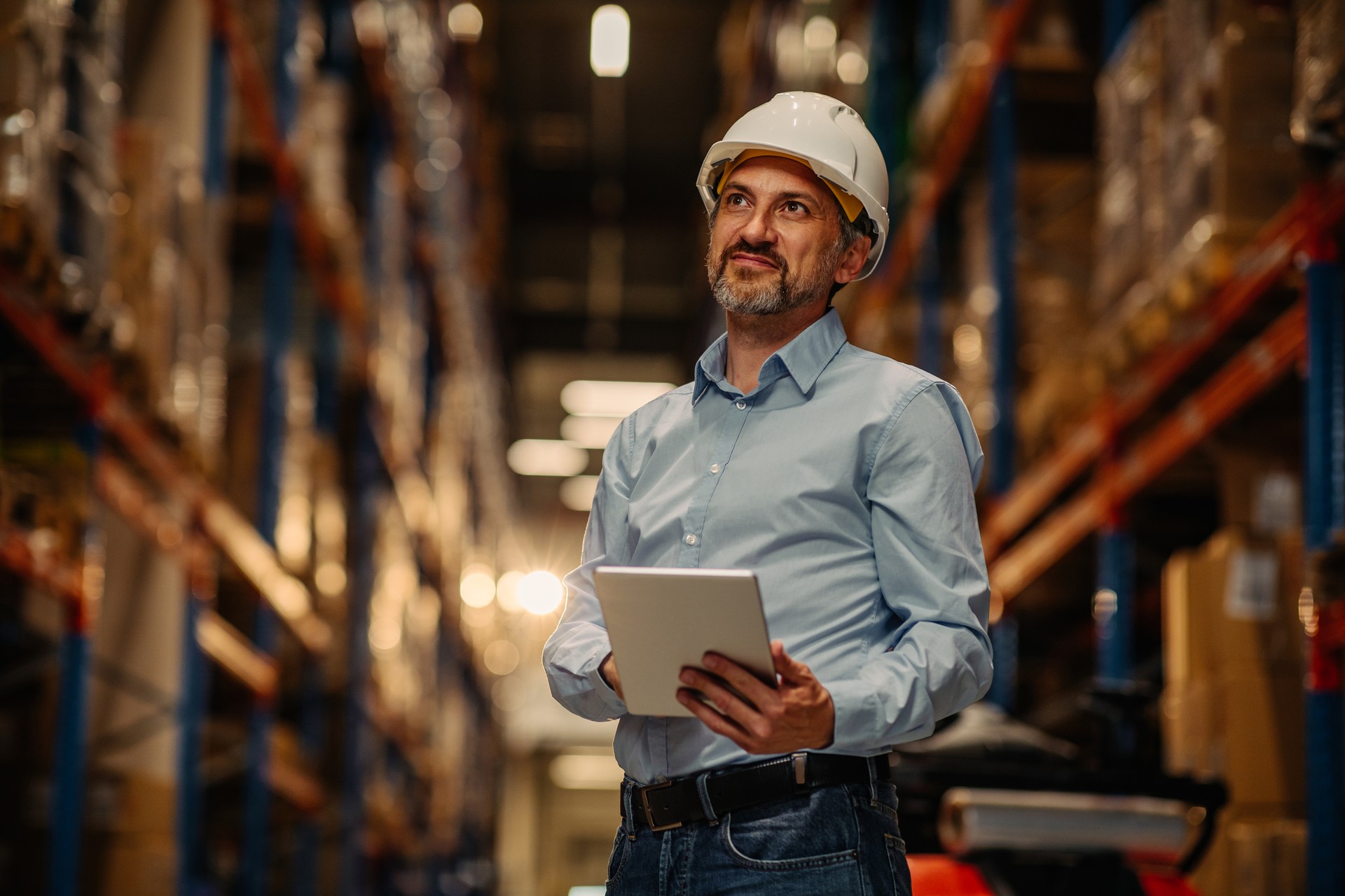 Man working in a warehouse via digital tablet