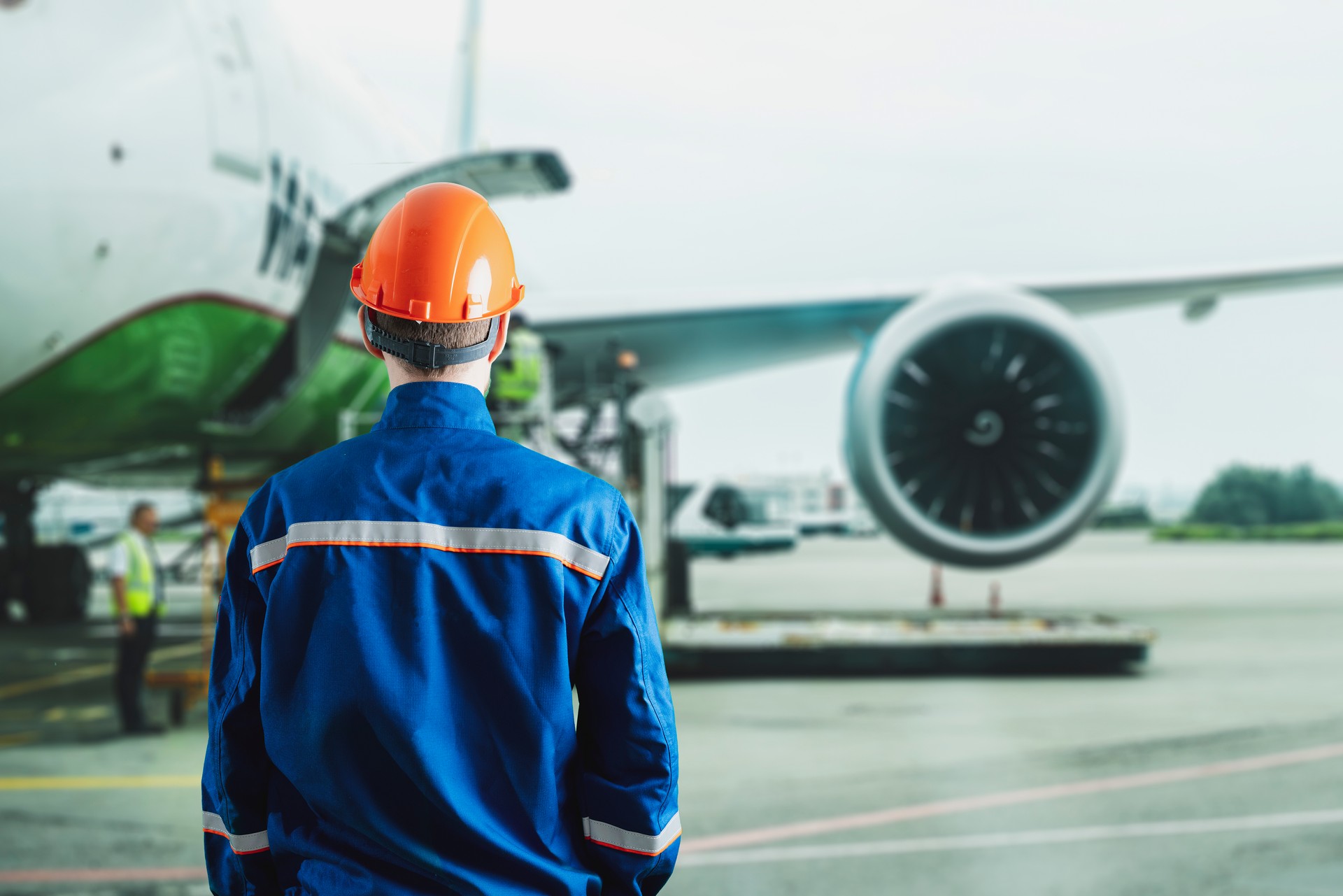 male worker in uniform in airport, traffic control of the plane